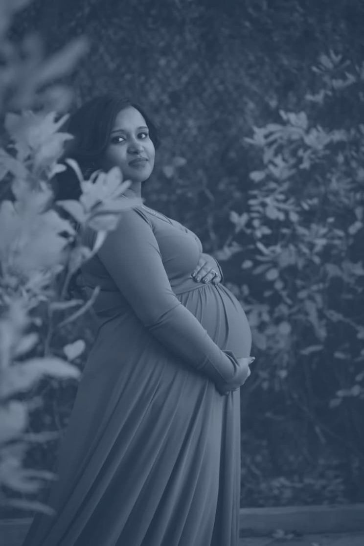 Woman letting a baby rest against her shoulder